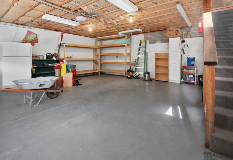 Poured garage floor slab with thickened edges over a vapor barrier and stone base